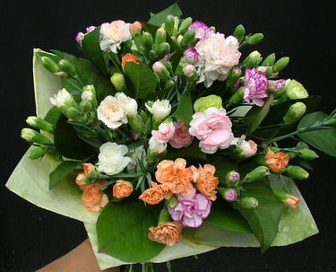 20 stems of mini carnations in a round bouquet